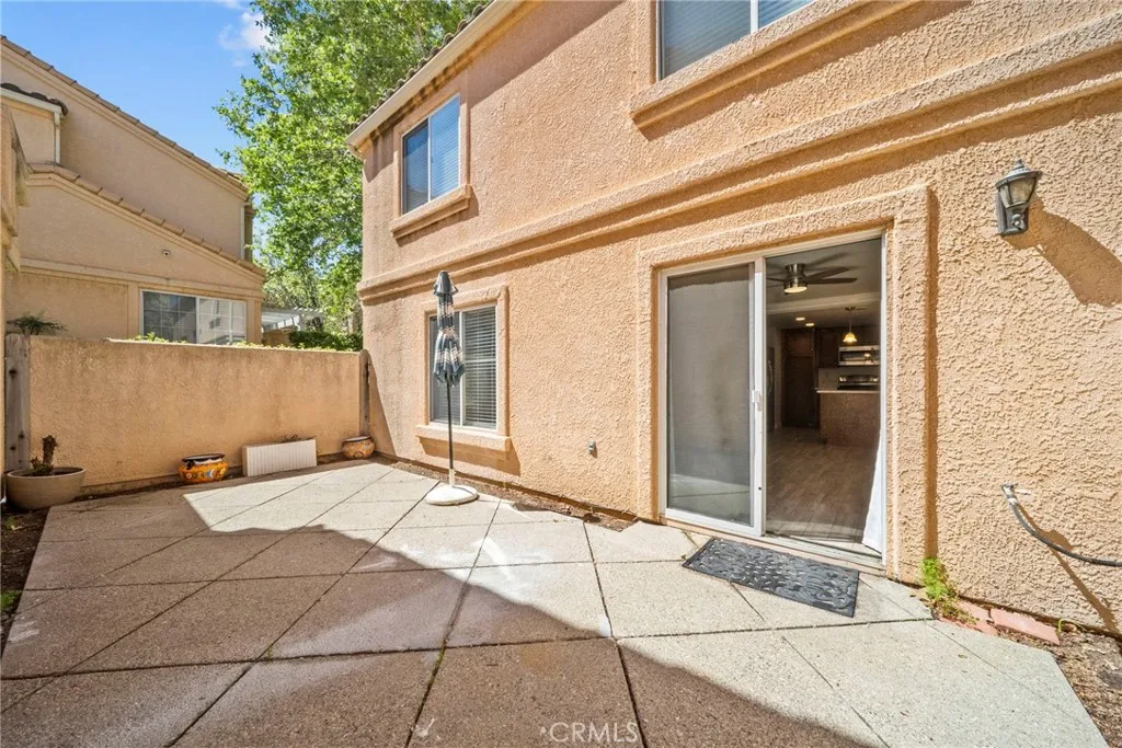 25118 Steinbeck Avenue Stevenson Ranch, CA 91381 - Photo 25 of 34 a view of a brick house with a outdoor space