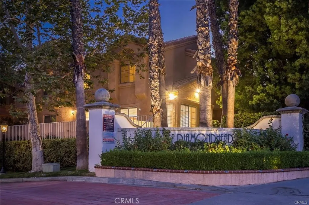 25118 Steinbeck Avenue Stevenson Ranch, CA 91381 - Photo 30 of 34 a view of a brick building next to a yard