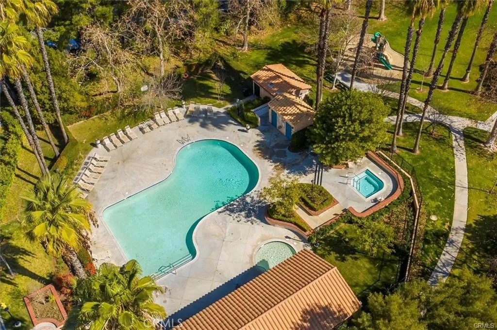 25118 Steinbeck Avenue Stevenson Ranch, CA 91381 - Photo 31 of 34 a view of a swimming pool with a yard