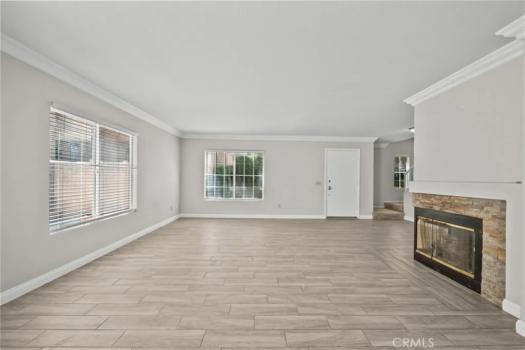 25118 Steinbeck Avenue Stevenson Ranch, CA 91381 - Photo 8 of 34 wooden floor fireplace and windows in an empty room