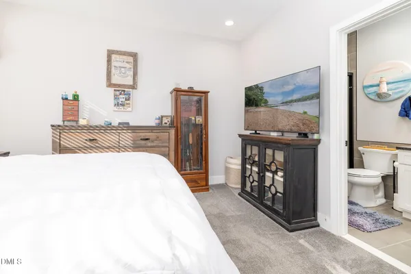 a bedroom with a bed and a television