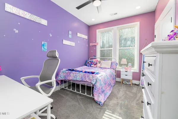 a bedroom with a bed and a chair