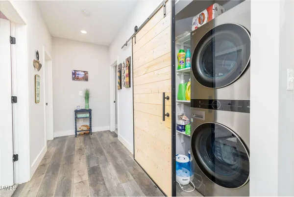 a view of a hallway with washer and dryer