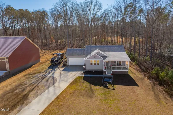 an aerial view of a house with a yard