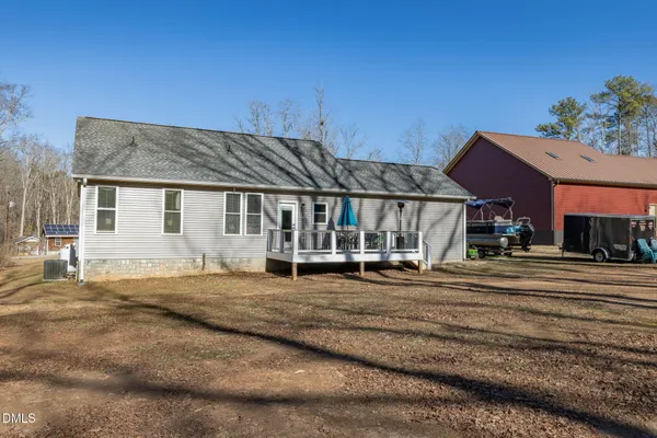 a view of a house with a bed and a yard