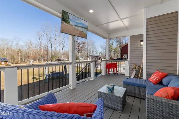 a balcony with furniture and wooden floor