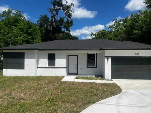 a house that has a tree in front of it