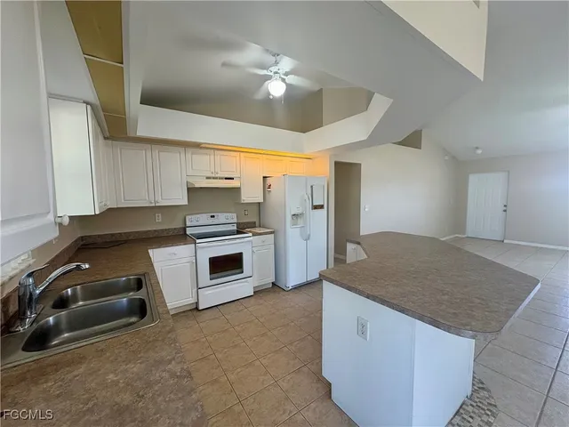 a kitchen with a stove and a sink