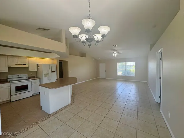 a view of a kitchen with a sink and dishwasher a kitchen island with wooden floor