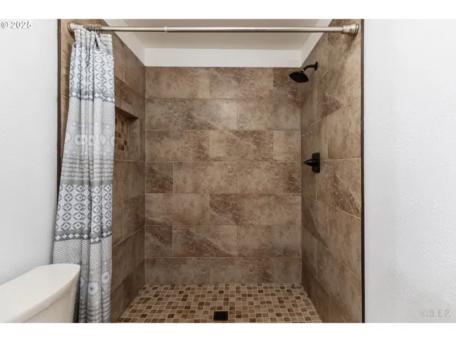 a bathroom with a shower and a toilet