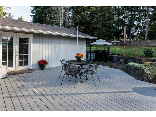 a patio with glass top table and chairs