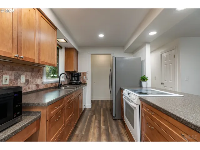 a kitchen with a sink stove and cabinets