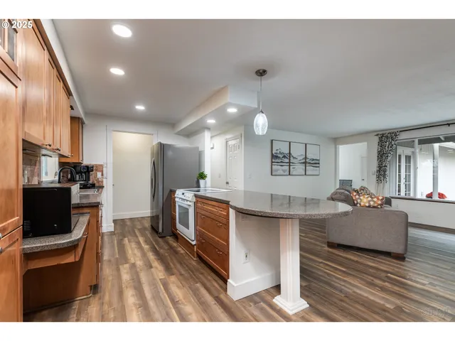 a open kitchen with cabinets and stainless steel appliances