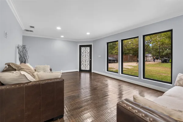 a living room with furniture and large windows