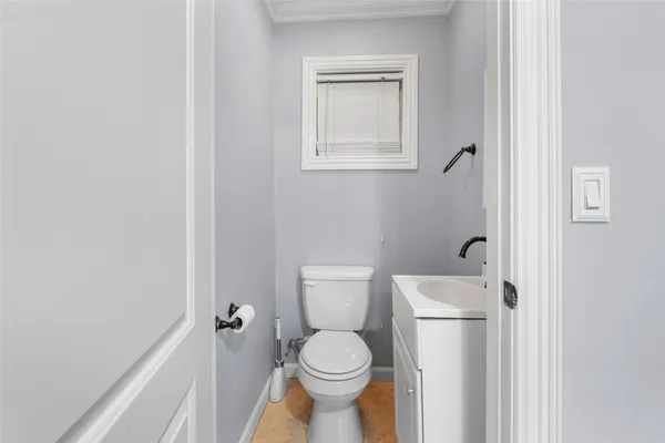 a white toilet sitting next to a bathroom sink