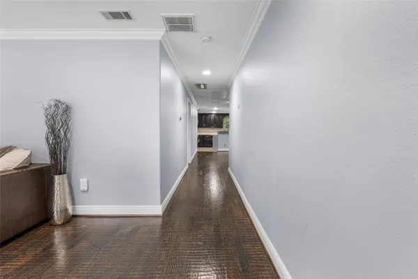 a view of a hallway with wooden floor and staircase