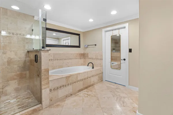 a bathroom with a bathtub and a shower