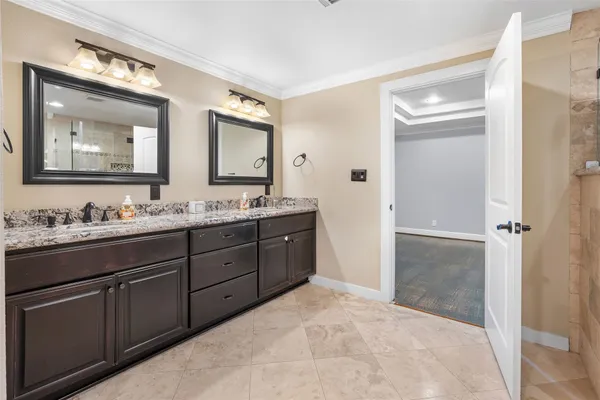 a bathroom with a granite countertop sink mirror and double