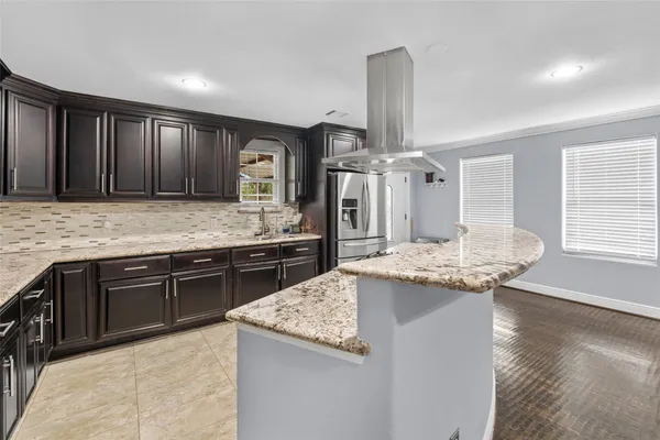 a kitchen with stainless steel appliances granite countertop a sink and stove