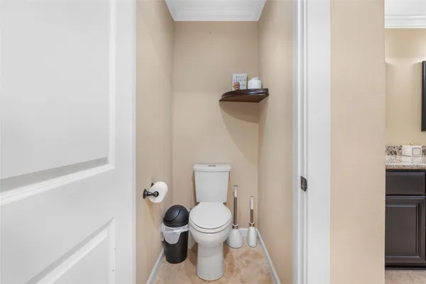 a white toilet sitting next to a bathroom sink
