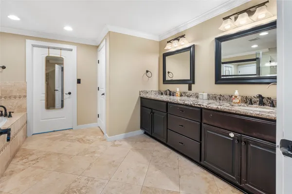 a bathroom with a granite countertop sink mirror and double
