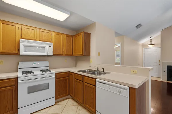 a kitchen with a sink stove and cabinets