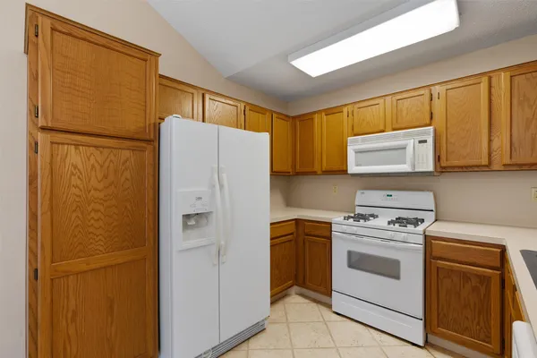 a kitchen with a refrigerator sink stove and microwave