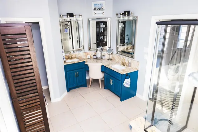 a bathroom with a sink a mirror and a shower