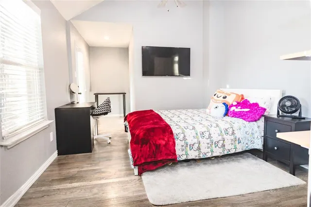 a bedroom with a bed and a flat screen tv