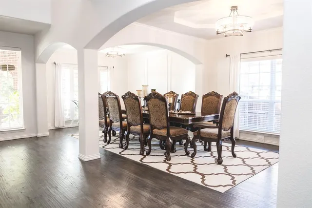 a view of a dining room with furniture and wooden floor
