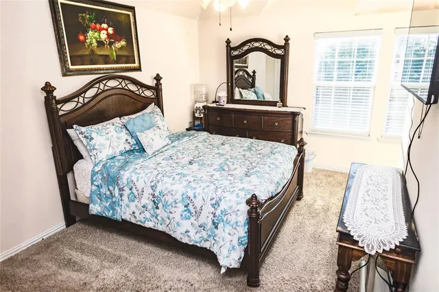 a bedroom with a bed and a table with chair