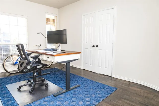 a view of a workspace with wooden floor