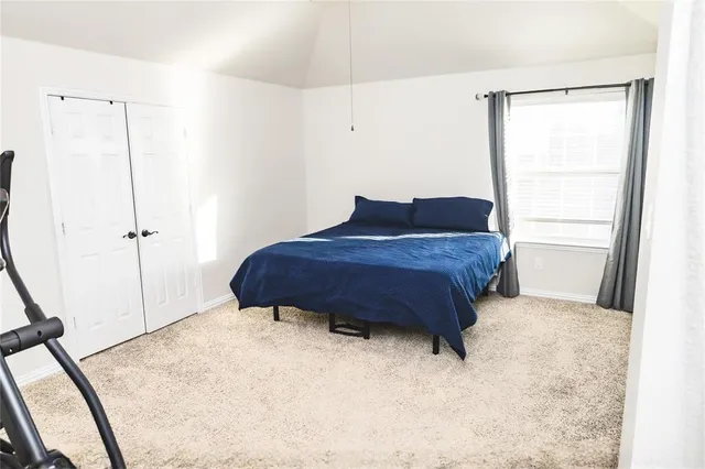 a room with a bed and a window