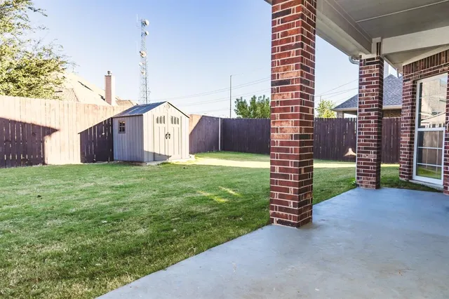 a view of a house with a yard and garage