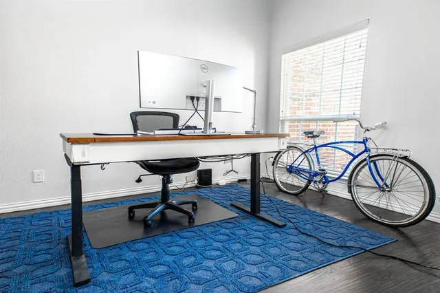 a view of a workspace with furniture window and wooden floor
