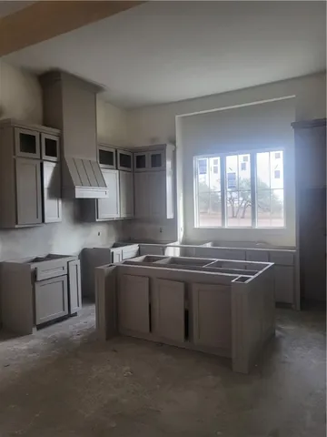 a kitchen with stainless steel appliances granite countertop a sink and a stove