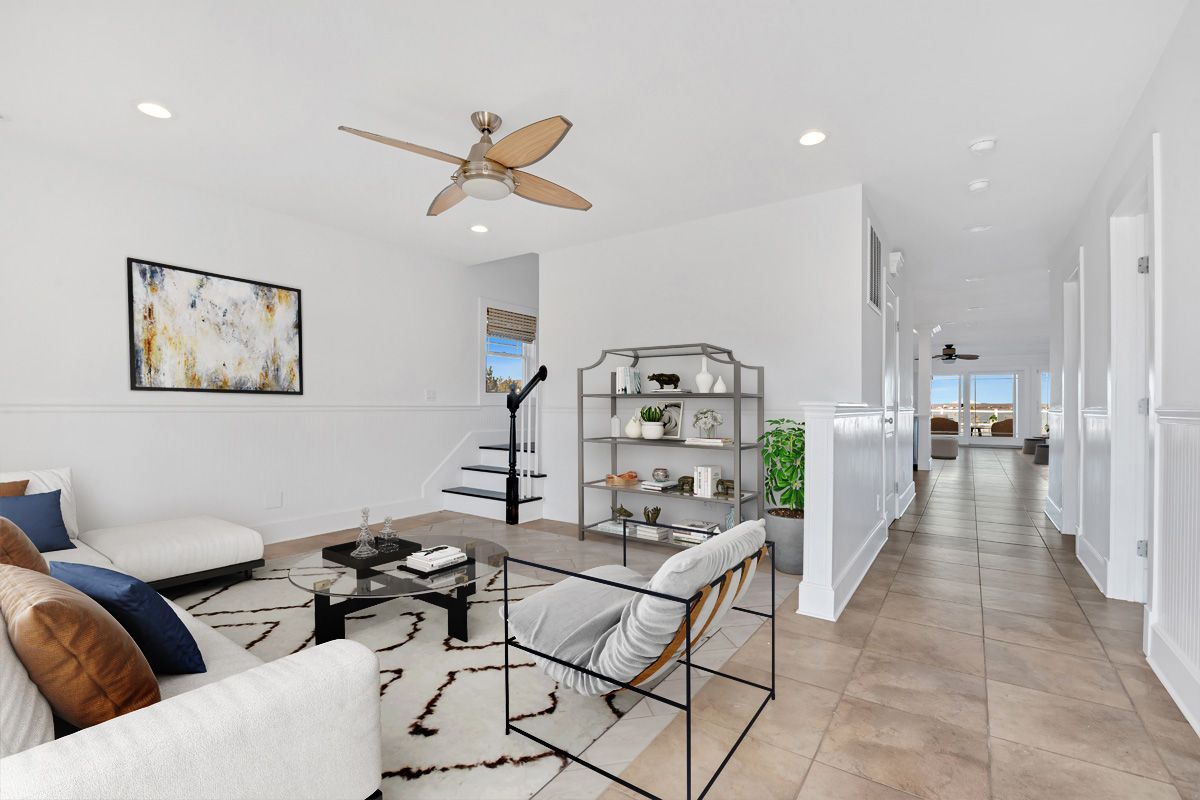798 Dune Road Westhampton Beach, NY 11978 - Photo 12 of 22 a living room with furniture and a book shelf