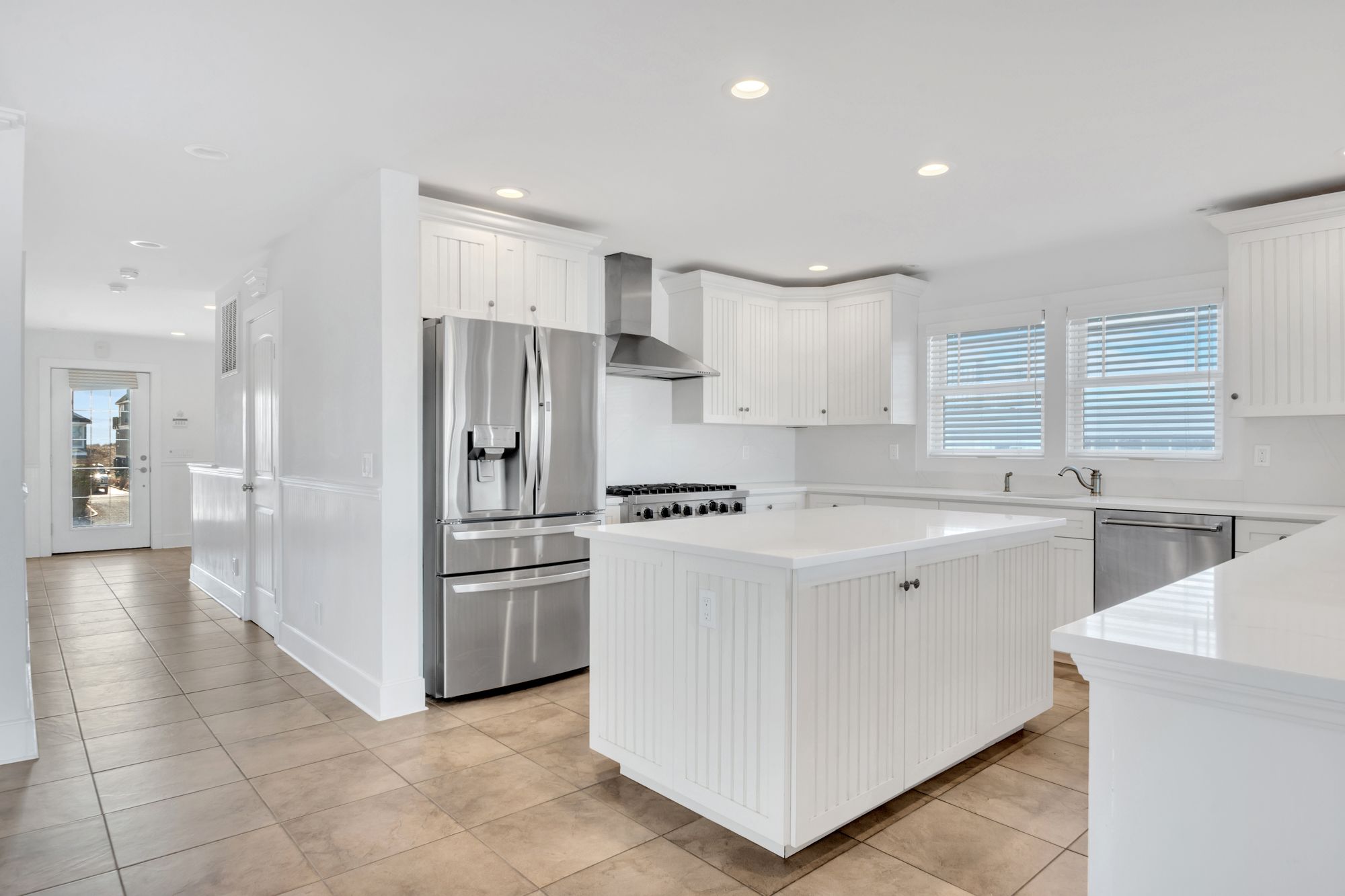 798 Dune Road Westhampton Beach, NY 11978 - Photo 9 of 22 a kitchen with a sink a refrigerator and cabinets