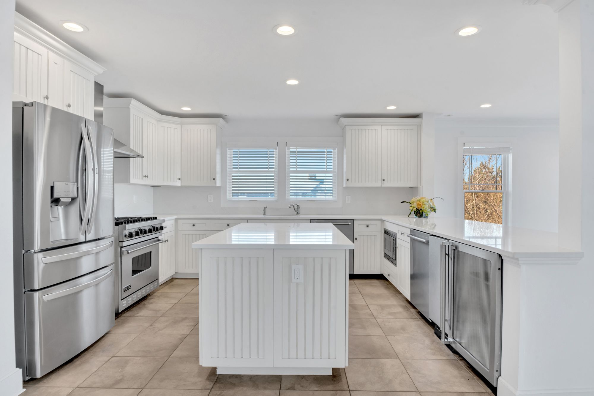 798 Dune Road Westhampton Beach, NY 11978 - Photo 10 of 22 a kitchen with a sink refrigerator and cabinets
