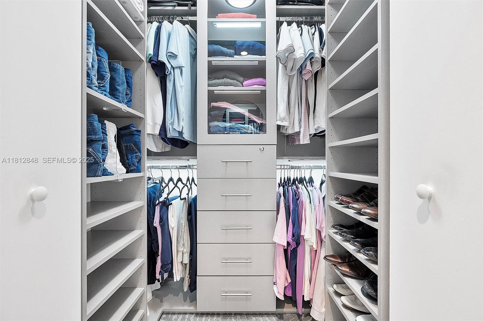 55 Southwest 9th Street, Unit 1510 Miami, FL 33130 - Photo 14 of 46 a view of walk in closet with clothes and shoes