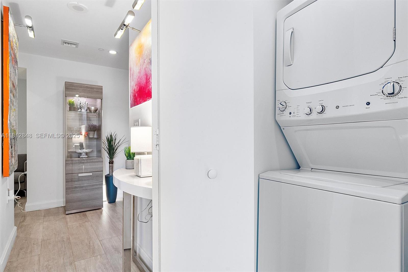 55 Southwest 9th Street, Unit 1510 Miami, FL 33130 - Photo 20 of 46 a view of washer and dryer with bathroom in the background