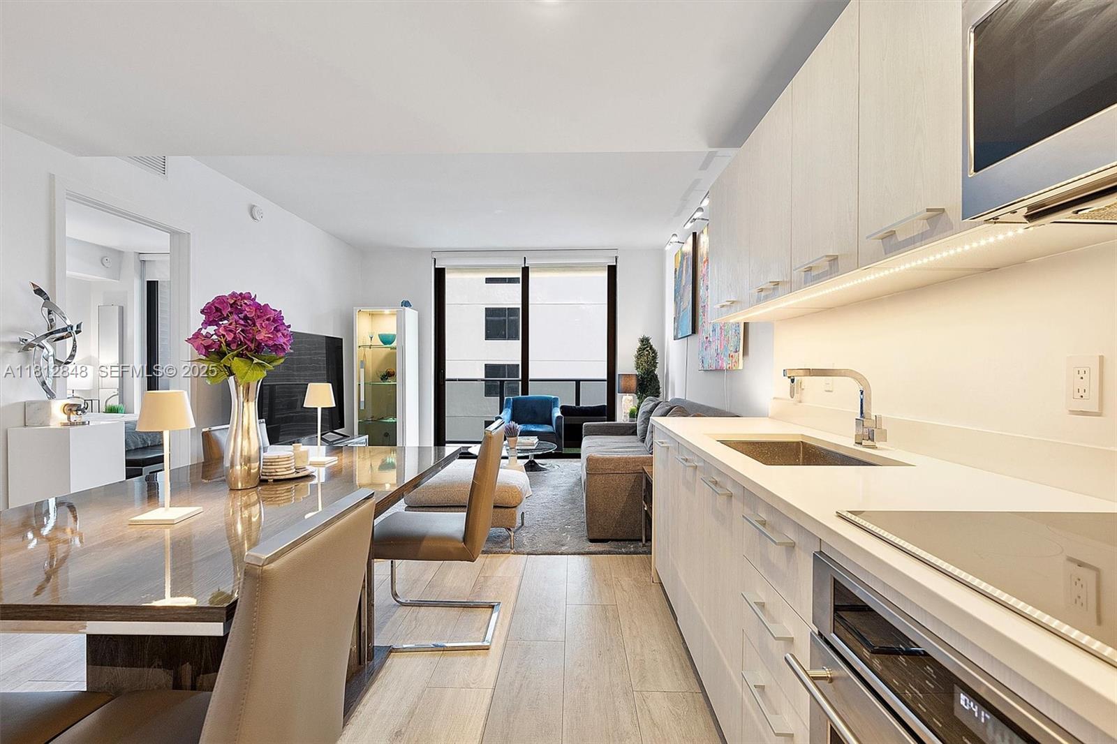 55 Southwest 9th Street, Unit 1510 Miami, FL 33130 - Photo 7 of 46 a kitchen with a sink stove and cabinets