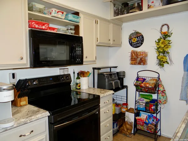 a kitchen with a stove and cabinets