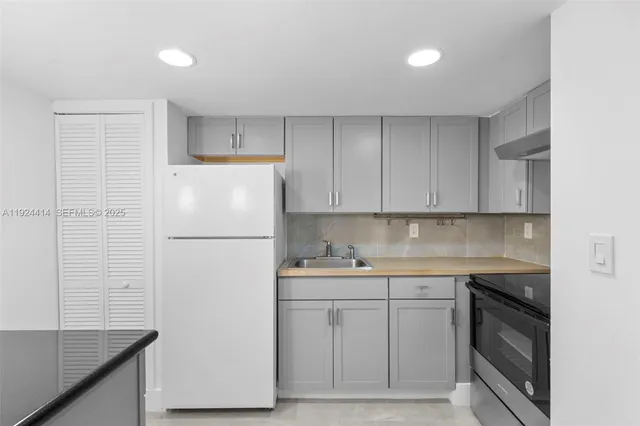 a white refrigerator freezer sitting inside of a kitchen