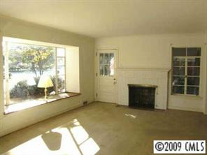 111 McAlway Road Charlotte, NC 28211 - Photo 5 of 8 a view of a living room with a fireplace and a floor to ceiling window
