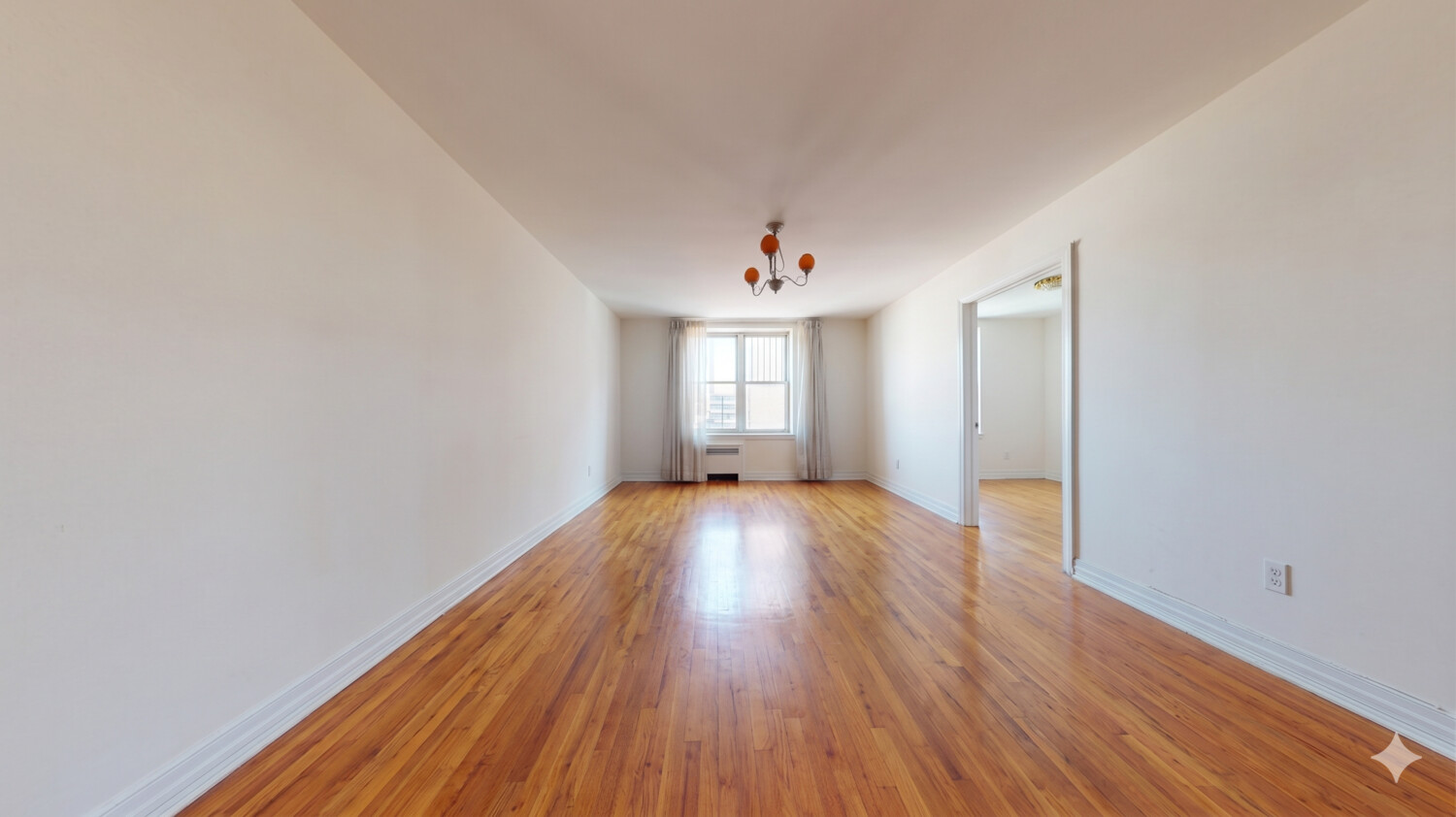 1200 Gravesend Neck Road, Unit 3L Brooklyn, NY 11229 - Photo 5 of 10 a view of an empty room with wooden floor and window