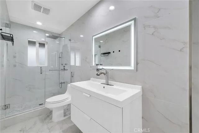 a bathroom with a sink toilet and shower