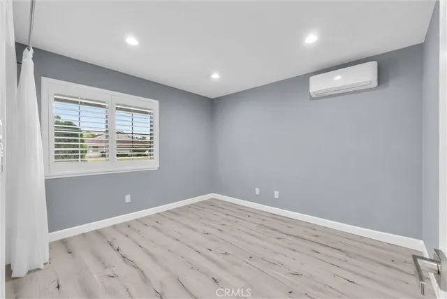 a room with wooden floor and windows