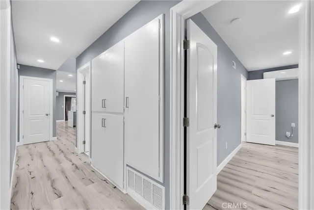 a view of a hallway with wooden floor and staircase