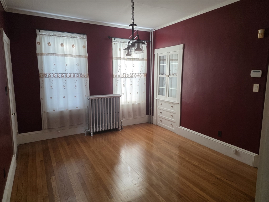 177 Highland Avenue, Unit 1 Fall River, MA 02720 - Photo 16 of 36 a view of an empty room with wooden floor and a window